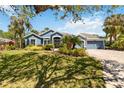 Charming single-story home featuring mature landscaping, a brick driveway, and a welcoming facade at 13136 Peregrin Cir, Bradenton, FL 34212