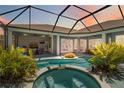 Enjoy the private screened-in pool and spa, surrounded by lush landscaping, and multiple access points to the house at 13136 Peregrin Cir, Bradenton, FL 34212