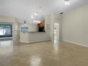 Open floor plan with tile flooring and a spacious living area leading to the kitchen at 15452 Long Cypress Dr, Ruskin, FL 33573