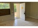 View of the front porch through the open doorway in this living room with tile floors at 2918 E Waters Ave, Tampa, FL 33604
