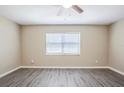 Cozy bedroom with neutral walls, window with blinds, and attractive gray wood-look flooring at 3645 6Th S St, St Petersburg, FL 33705