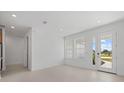Bright living space featuring tiled floors, large windows, and glass doors that provide ample natural light at 7338 N Ficus Tree, Punta Gorda, FL 33955