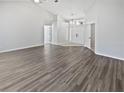 Open-concept living room with hardwood floors and a bright, airy atmosphere at 8080 Spanish Oak Dr, Spring Hill, FL 34606
