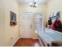 Welcoming entryway with hardwood floors, coat rack and a window providing natural light at 11805 Castine St, New Port Richey, FL 34654