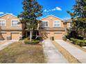 Inviting townhome community with manicured lawns, mature trees, and convenient garage parking at 11805 Castine St, New Port Richey, FL 34654