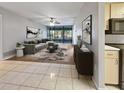 View of a staged living room with neutral colors, a modern sofa, and decor at 612 Bird Bay S Dr # 113, Venice, FL 34285