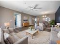 Cozy living room featuring modern furnishings, neutral color palette, and an open concept design to the dining area at 6507 Stone River Rd # 310, Bradenton, FL 34203