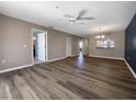 Spacious open-plan living room with wood flooring, ceiling fan, and neutral walls offers versatile design options at 6507 Stone River Rd # 310, Bradenton, FL 34203