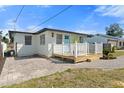 Charming exterior view of a home with a light blue door, white trim, and a cozy front deck at 1805 Rita St, Sarasota, FL 34231