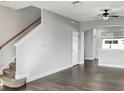 Spacious living room with dark wood style floors and stairwell perfect for entertaining at 8840 Red Beechwood Ct, Riverview, FL 33578