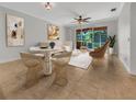 Open-concept living room features bright, neutral decor and access to outdoor screened-in lanai at 11535 52Nd E Ct, Parrish, FL 34219