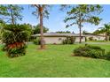 Beautifully landscaped backyard with mature trees and lush greenery, offering a private oasis at 4337 Marine Pkwy, New Port Richey, FL 34652