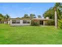 Expansive backyard with lush green grass and mature trees, ideal for outdoor enjoyment at 4337 Marine Pkwy, New Port Richey, FL 34652