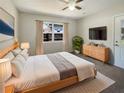 Bright bedroom featuring a ceiling fan, television, and a large window with natural light at 120 W Wildwood St, Tampa, FL 33613
