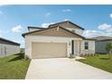 Charming two-story home featuring a 2-car garage and a well-manicured lawn at 31653 Wild Grape Ln, Brooksville, FL 34602