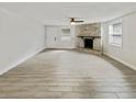 Spacious living room featuring a stone fireplace, large windows, and modern tile flooring at 4907 E Clifton St, Tampa, FL 33610