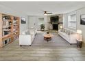 Bright living room with stylish striped rug, stone fireplace, and modern furniture at 4907 E Clifton St, Tampa, FL 33610