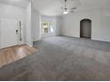 Expansive living room with neutral tones, large windows, and ample space for furniture at 6191 Silverdale Ave, Spring Hill, FL 34608