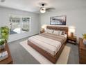 Spacious main bedroom featuring a king bed, soft rug, stylish furnishings, and a sunlit window view at 6191 Silverdale Ave, Spring Hill, FL 34608