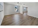 Spacious living room with laminate flooring, neutral walls, and a ceiling fan at 6804 11Th W St, Bradenton, FL 34207