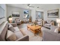 Bright living room with neutral colors, comfortable seating, and a large area rug at 6804 11Th W St, Bradenton, FL 34207
