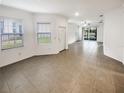 Bright living room featuring neutral walls and tile floors at 6856 Ripple Pond Loop, Zephyrhills, FL 33541