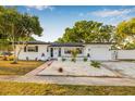 Charming single-Gathering home with well-maintained landscaping and a lovely walkway leading to the entrance at 5980 32Nd N Ave, St Petersburg, FL 33710