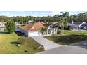 Inviting home featuring a lush lawn, palm trees, and a convenient two-car garage at 4320 Genesee Ln, New Port Richey, FL 34655