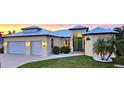 Charming home with a metal roof, lush landscaping, and a well-maintained lawn, creating a welcoming curb appeal at 3215 Peace River Dr, Punta Gorda, FL 33983