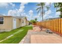 Backyard featuring well kept fence, manicured lawn, and outdoor patio area at 3803 Pin Oaks St, Sarasota, FL 34232