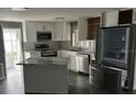 Modern kitchen features stainless appliances, white cabinets and an island at 125 Dolphin S Dr, Oldsmar, FL 34677