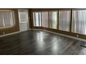 Bright living room features a wall of windows and lovely vinyl floors at 125 Dolphin S Dr, Oldsmar, FL 34677