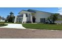 Beautiful home displaying a manicured lawn, an elegant front entrance, and architectural charm at 5900 Leeland S St, St Petersburg, FL 33715