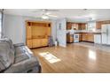 Open living space with wood floors seamlessly connects to the adjacent kitchen at 909 Kirkcaldy Way, Valrico, FL 33594