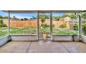 Relaxing screened patio showcases a fenced backyard with ample lawn space at 909 Kirkcaldy Way, Valrico, FL 33594