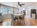Open concept dining area that flows into a kitchen, filled with natural light from a large window at 1121 49Th Ave N, St Petersburg, FL 33703