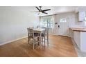 Bright dining area featuring hardwood floors, a ceiling fan, and a view to the front yard at 1121 49Th Ave N, St Petersburg, FL 33703