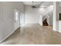 Neutral living room with tile floors, high ceilings, and staircase to the second floor at 9509 Citrus Glen Pl # 11, Tampa, FL 33618