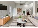 Bright living room features contemporary decor with a neutral palette, tile flooring, and an open staircase at 9509 Citrus Glen Pl # 11, Tampa, FL 33618