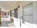 Exterior entrance of unit with white door and screen, showcasing building details and natural light at 2353 Shelley St # 8, Clearwater, FL 33765
