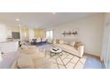 Spacious living room featuring neutral furniture, open to the dining area, with light-colored walls and ample natural light at 14699 Italy Ave, Dade City, FL 33523