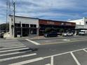 Street-level view of commercial buildings with retail shops, on-street parking, and pedestrian crosswalk at 36157 Canelli Way, Dade City, FL 33523