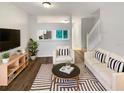 Bright living room featuring hardwood floors, modern decor, and lots of natural light and open floor plan at 1238 Standridge Dr, Wesley Chapel, FL 33543
