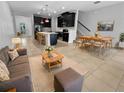 Open-concept living area with modern kitchen, dining space, and comfortable seating arrangement at 1998 Milkweed Trce, Lutz, FL 33558