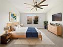 Bright main bedroom featuring a modern bed, stylish decor, and ample natural light at 1998 Milkweed Trce, Lutz, FL 33558