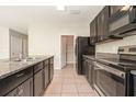 Spacious kitchen boasting granite countertops, stainless steel appliances, and ample cabinet space at 11807 Myrtle Rock Dr, Riverview, FL 33578