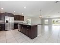 Open kitchen with stainless steel appliances and granite countertops overlooks the living area at 13581 Willow Bluestar Loop, Riverview, FL 33579