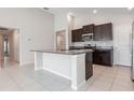 Bright kitchen features an island, granite countertops, and stainless steel appliances at 13581 Willow Bluestar Loop, Riverview, FL 33579