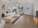 Bright living room featuring a cozy seating area and a decorative fireplace at 1404 Rosewood Ave, Dunedin, FL 34698