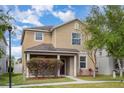 Attractive two-story home with a well-maintained front yard, covered porch, and beautiful landscaping at 13417 Lake Monroe Pl, Riverview, FL 33579